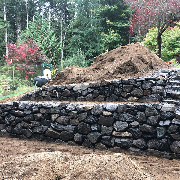 Terraced rock retaining wall